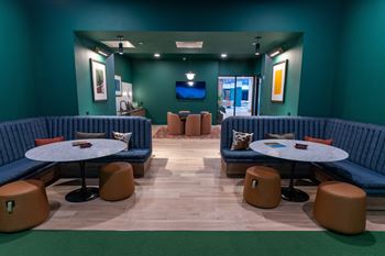 A room with blue booths and tables.